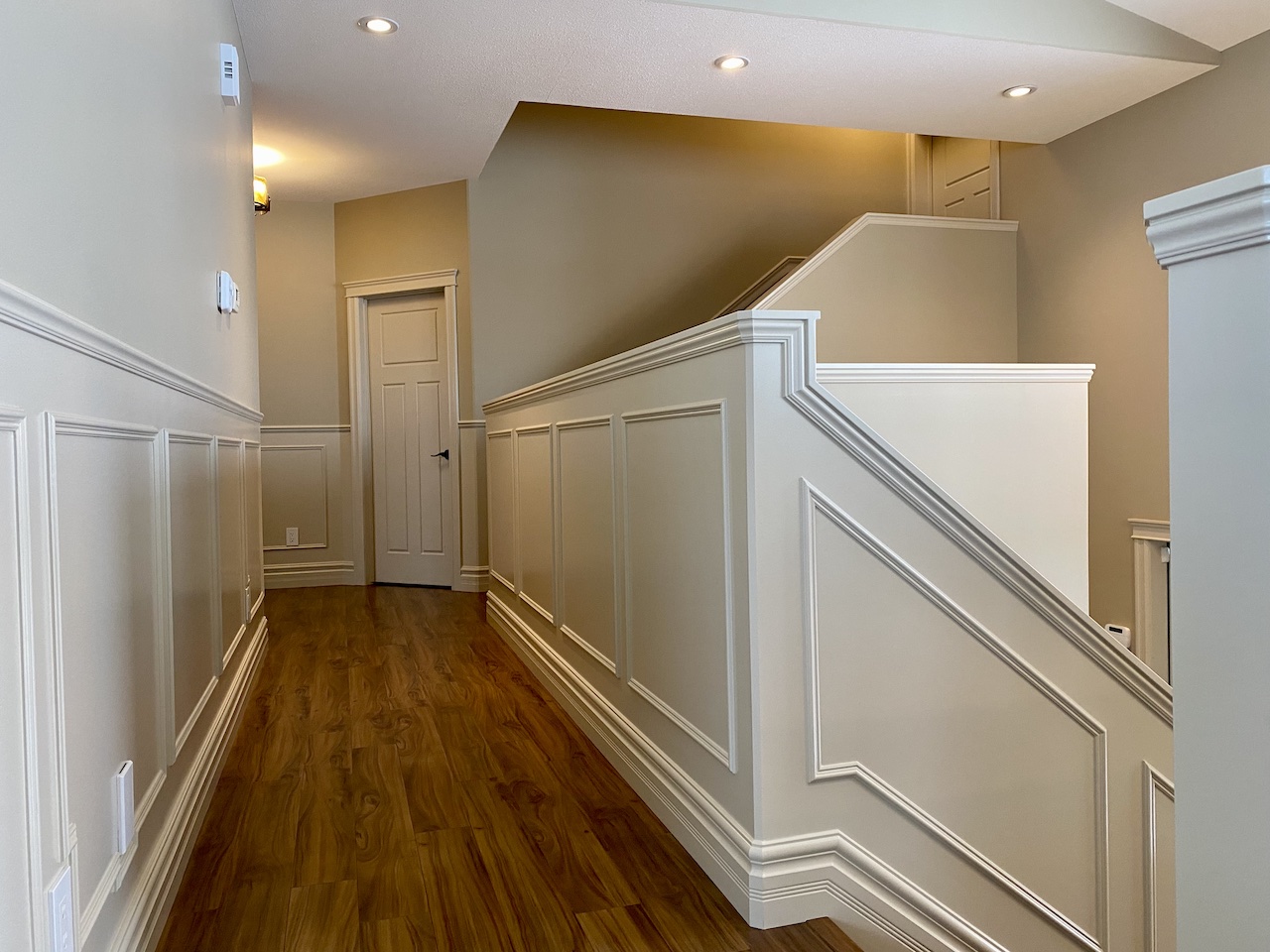 Walkout basement with dark cabinetry and gold accents, bright and spacious with floor to ceiling windows 